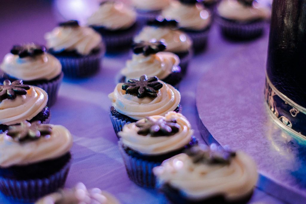 Chocolate muffins with cream served on festive table